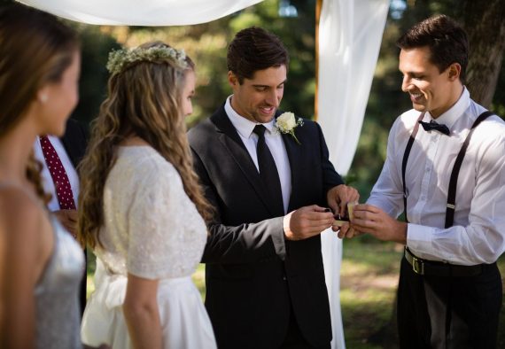 Waiter giving engagement ring to groom